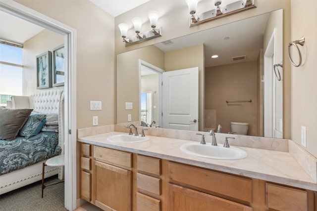 bathroom featuring vanity and toilet