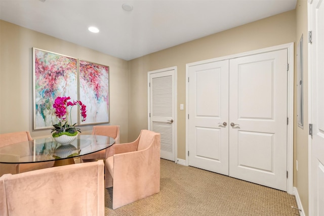 dining space featuring light carpet