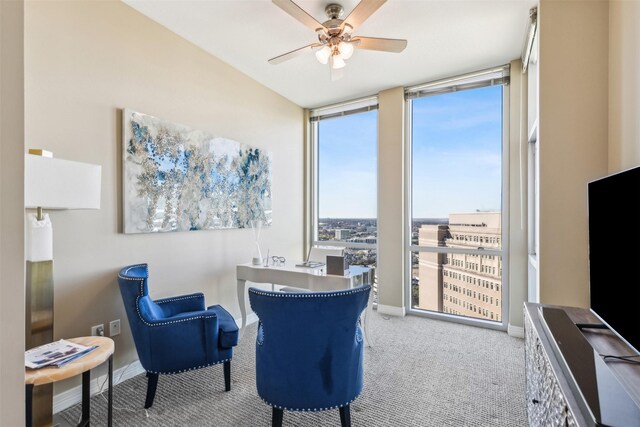 sitting room with light carpet, floor to ceiling windows, and ceiling fan