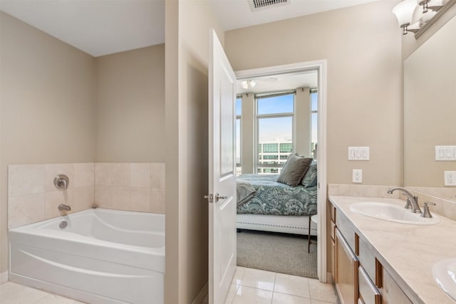 bathroom featuring a tub, tile patterned flooring, and vanity