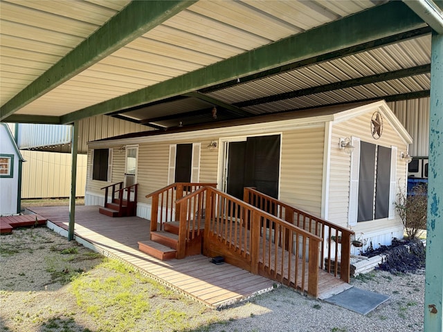 view of exterior entry with a deck