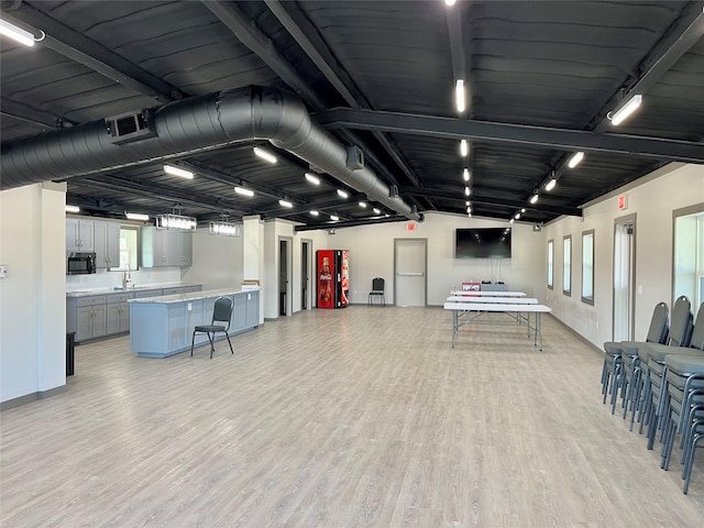 interior space with light hardwood / wood-style floors, a healthy amount of sunlight, and track lighting