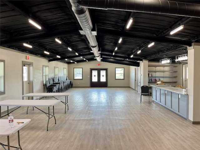 game room featuring french doors, rail lighting, and light wood-type flooring