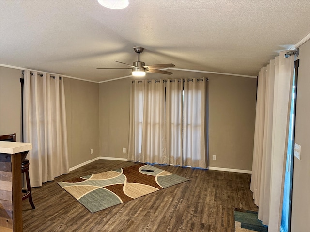 interior space with crown molding, dark wood-type flooring, and a textured ceiling