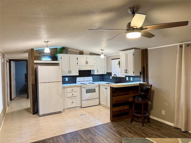 kitchen with white appliances, white cabinetry, lofted ceiling, and backsplash