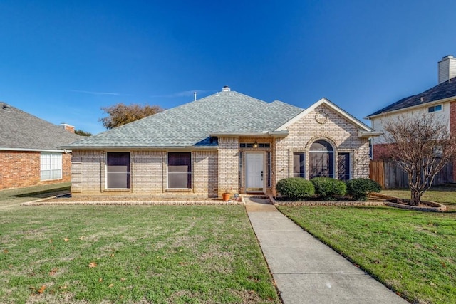 ranch-style home with a front lawn