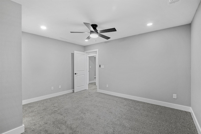 carpeted spare room featuring ceiling fan