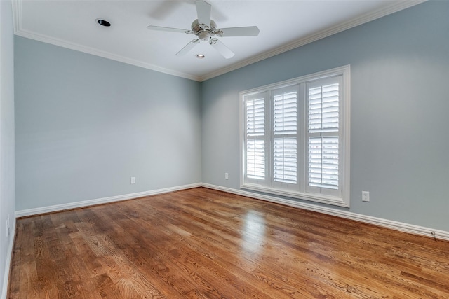 empty room with ceiling fan, wood-type flooring, and crown molding