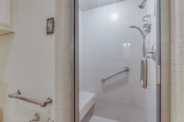 bathroom with a shower with door