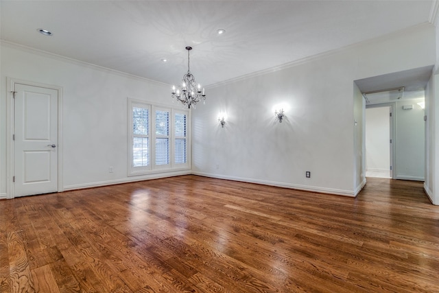 unfurnished room with ornamental molding, dark wood-type flooring, and a notable chandelier