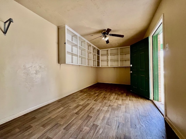 spare room featuring hardwood / wood-style floors and ceiling fan