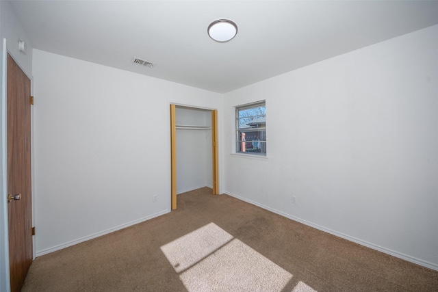 unfurnished bedroom with carpet floors and a closet