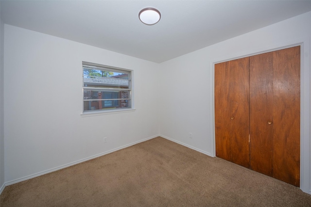 unfurnished bedroom with carpet flooring and a closet