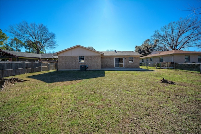 rear view of property with a lawn