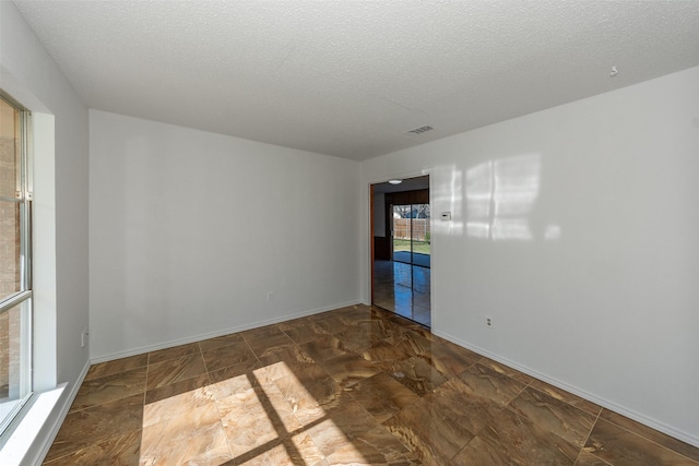 empty room with a textured ceiling