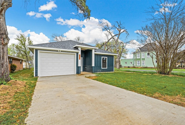 view of front of home with a garage and a front lawn