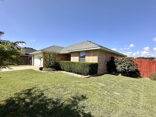 view of front of home with a front lawn and a garage