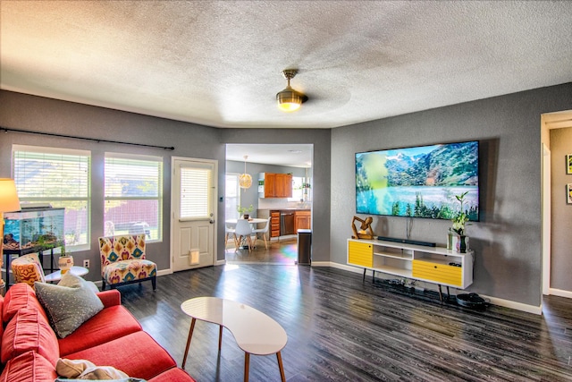 living room featuring ceiling fan and dark wood-type flooring