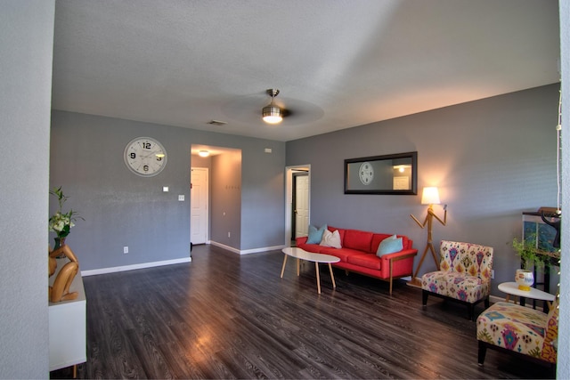 living room with ceiling fan and dark wood-type flooring