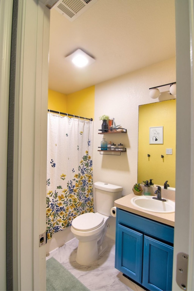 bathroom featuring vanity and toilet