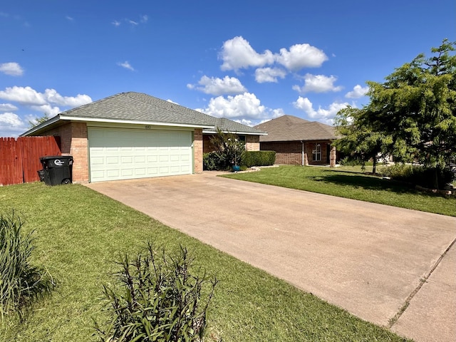 ranch-style home featuring a garage and a front lawn