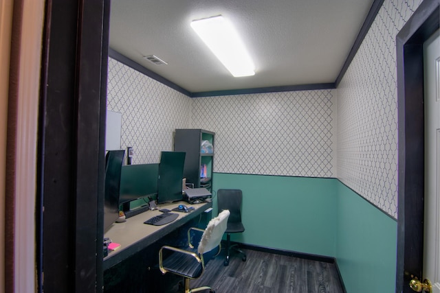 home office with dark hardwood / wood-style flooring, built in desk, a textured ceiling, and ornamental molding