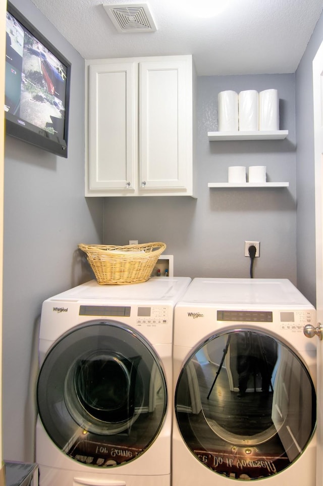 laundry area with cabinets and independent washer and dryer