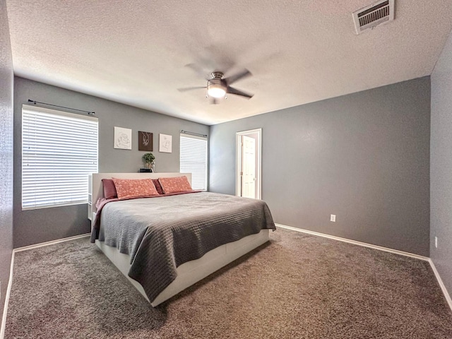 bedroom with carpet flooring, ceiling fan, and multiple windows