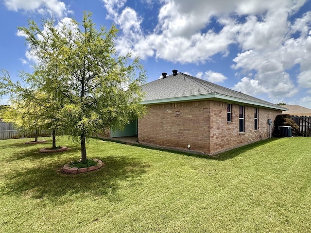 view of property exterior featuring central AC unit and a lawn