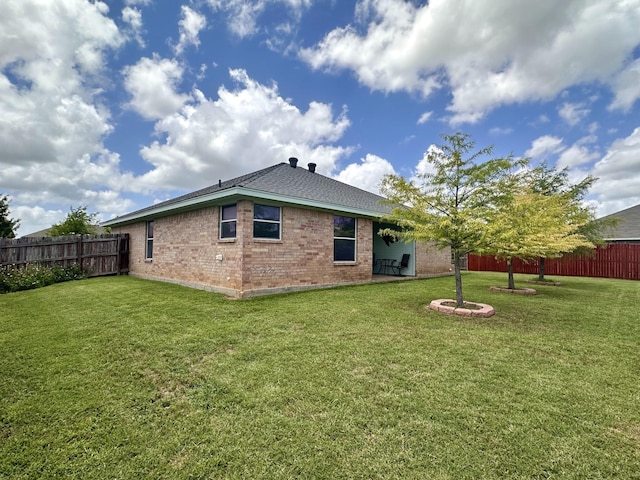 rear view of property with a yard