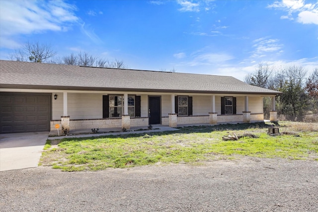 view of front of house featuring covered porch and a garage