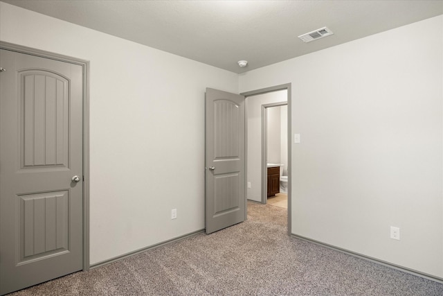 unfurnished bedroom featuring light carpet