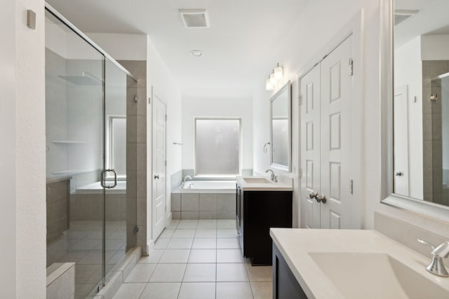 bathroom featuring vanity, tile patterned flooring, and plus walk in shower