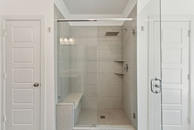 bathroom featuring a shower with door