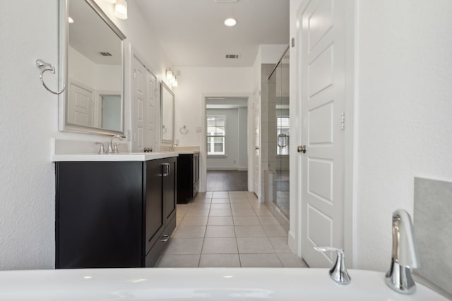 bathroom featuring tile patterned floors, vanity, and an enclosed shower