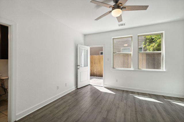 spare room featuring ceiling fan and dark hardwood / wood-style floors