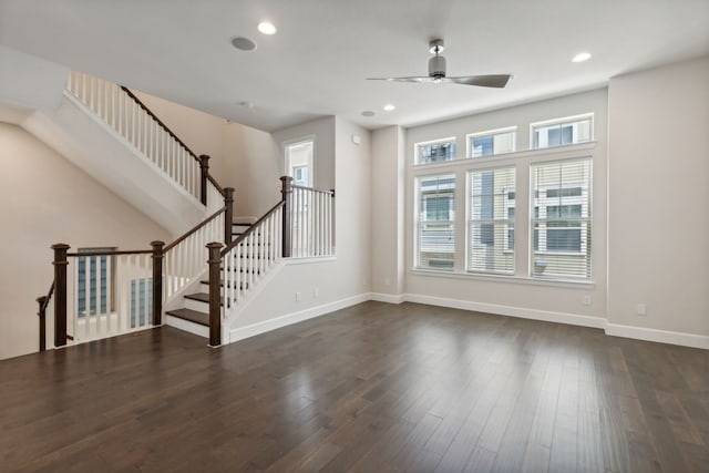 unfurnished living room with ceiling fan and dark hardwood / wood-style flooring