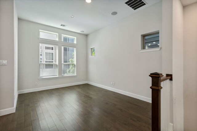 empty room with dark hardwood / wood-style floors