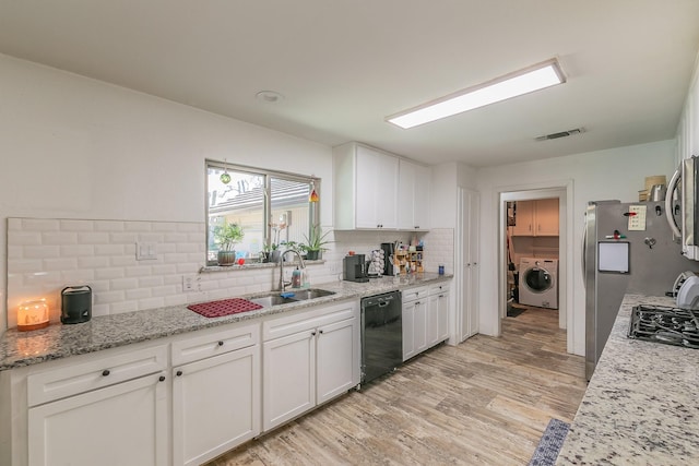 kitchen featuring sink, light hardwood / wood-style flooring, appliances with stainless steel finishes, light stone counters, and white cabinetry