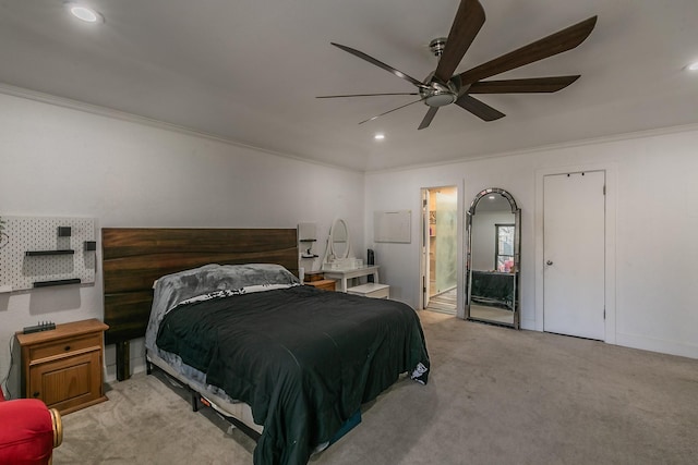 carpeted bedroom with ensuite bath, ceiling fan, and ornamental molding