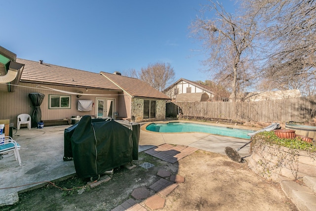 view of pool featuring a grill, a patio area, and french doors