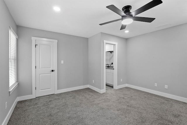 unfurnished bedroom featuring light carpet and ceiling fan