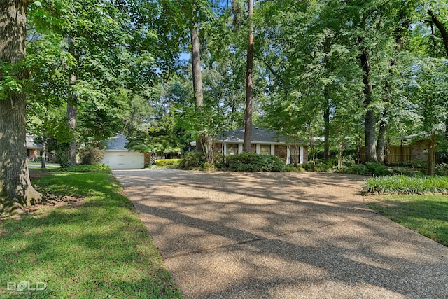 view of front of property with a garage and a front lawn