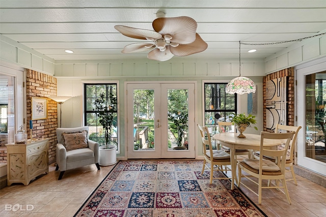 sunroom / solarium featuring french doors and ceiling fan