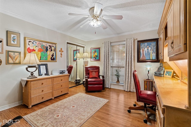 office with ceiling fan, ornamental molding, a textured ceiling, and light wood-type flooring