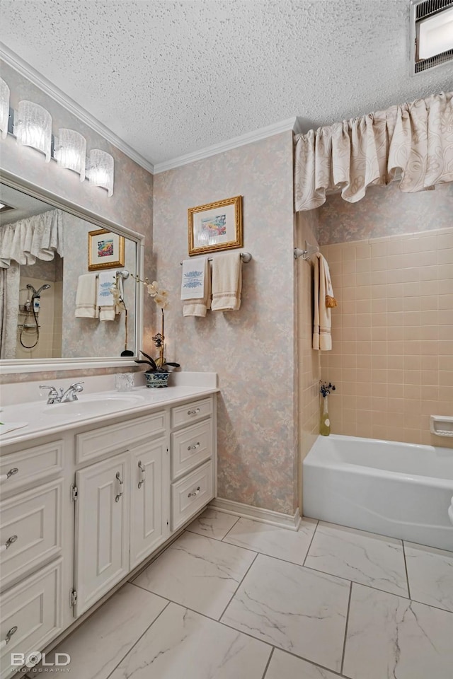 bathroom featuring tiled shower / bath combo, a textured ceiling, ornamental molding, and vanity