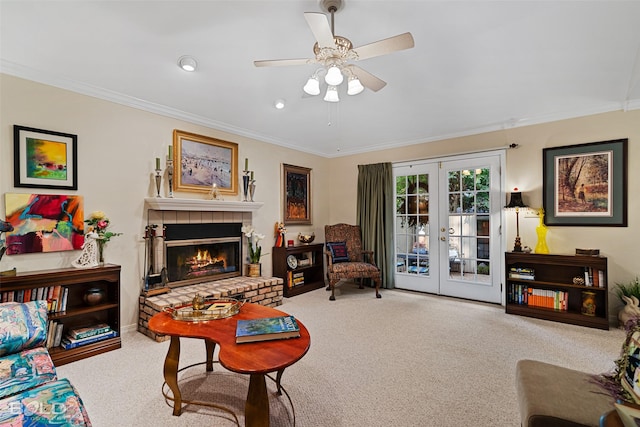 living room with carpet flooring, french doors, ornamental molding, ceiling fan, and a brick fireplace