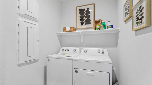 laundry area with separate washer and dryer and electric panel