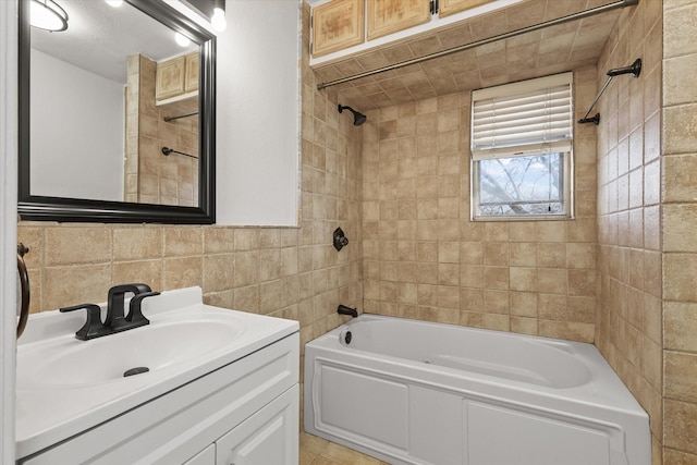 bathroom featuring vanity, tiled shower / bath combo, and tile walls