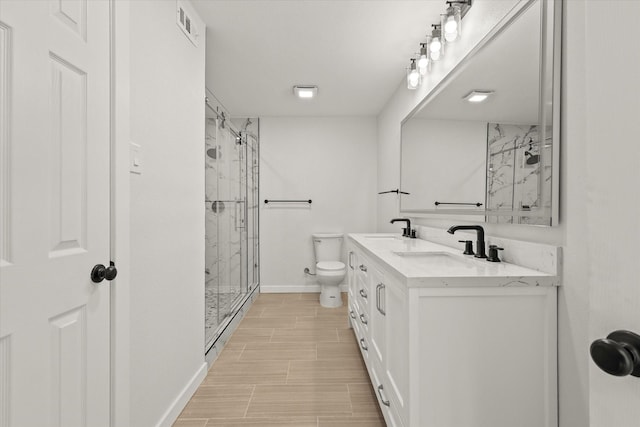 bathroom featuring vanity, toilet, and walk in shower